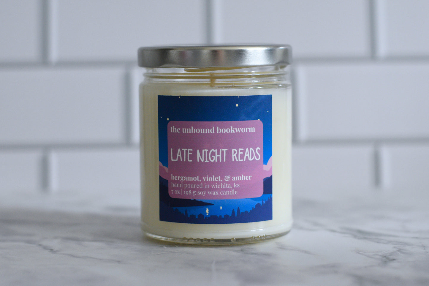 Bergamot, Violet, & Amber scented bookish candle titled "Late Night Reads"