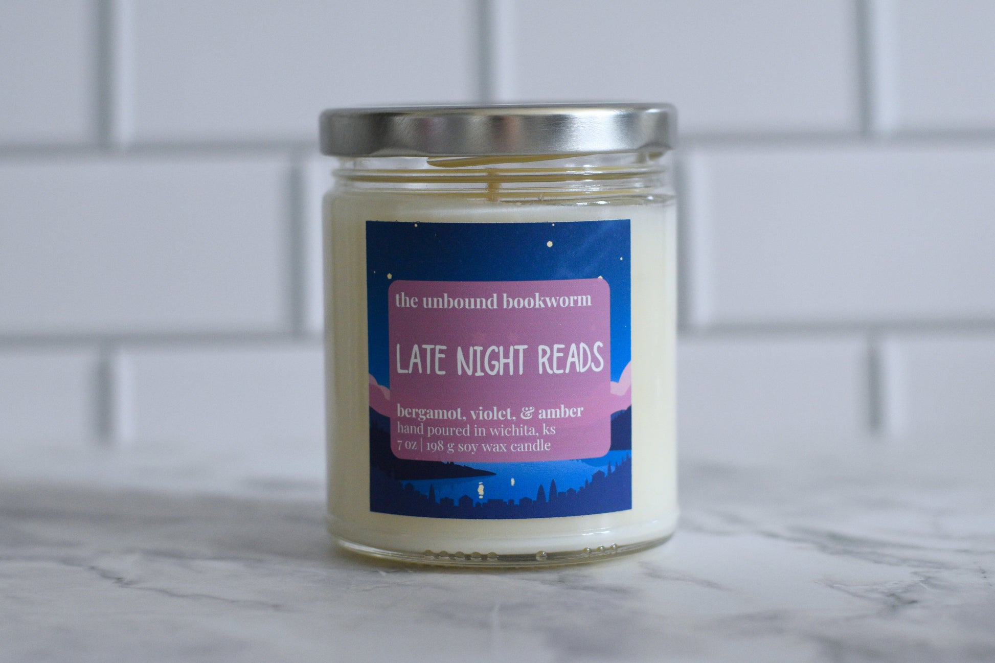 Bergamot, Violet, & Amber scented bookish candle titled "Late Night Reads"